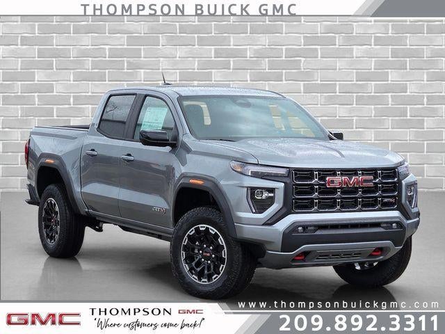 2026 GMC Canyon AT4 in Sterling Metallic — front three-quarter view